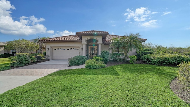 mediterranean / spanish house featuring a front yard and a garage