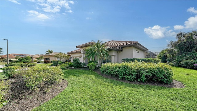 view of home's exterior with a yard and a garage