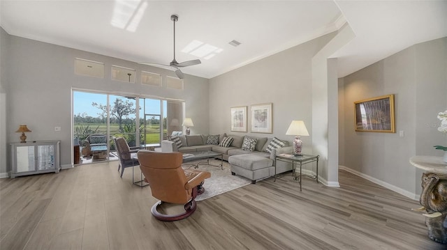 living room with ceiling fan and light wood-type flooring