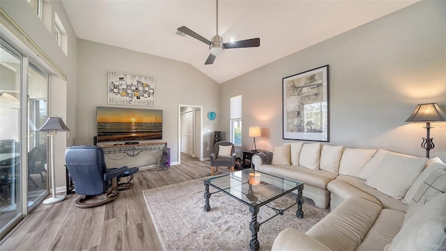 living room featuring ceiling fan, wood-type flooring, and lofted ceiling