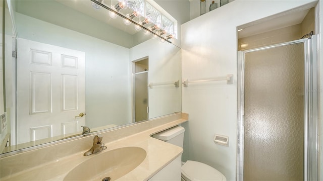 bathroom with toilet, vanity, and walk in shower