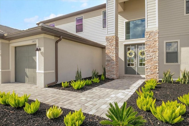 doorway to property with a garage