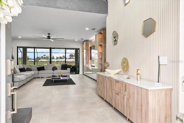 kitchen with ceiling fan and light brown cabinets