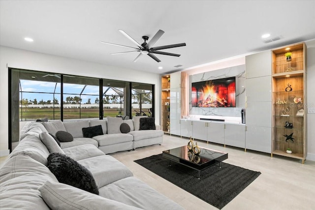 living room featuring ceiling fan and a wealth of natural light