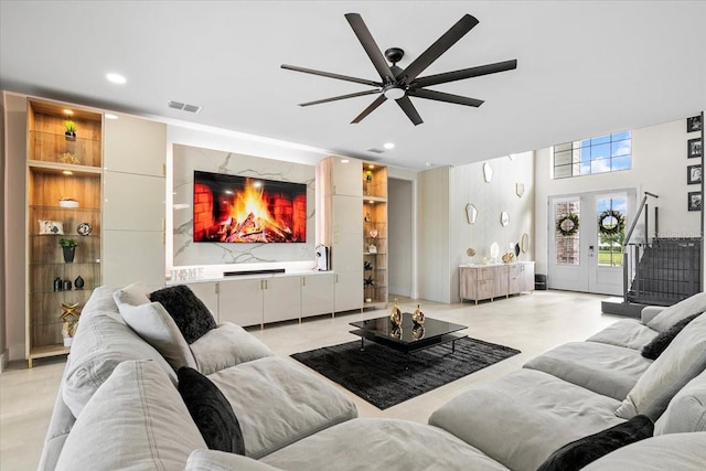 living room with ceiling fan and french doors