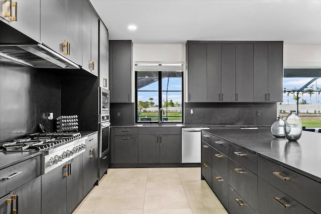 kitchen featuring light tile patterned floors, stainless steel appliances, tasteful backsplash, and sink