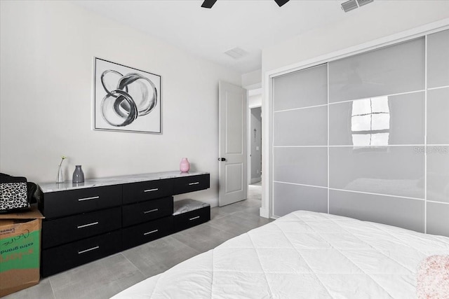 bedroom with ceiling fan and a closet