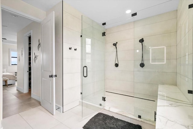 bathroom with tile patterned flooring and a shower with door