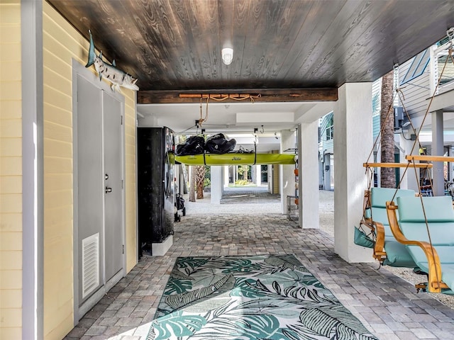 interior space featuring beamed ceiling and wooden ceiling