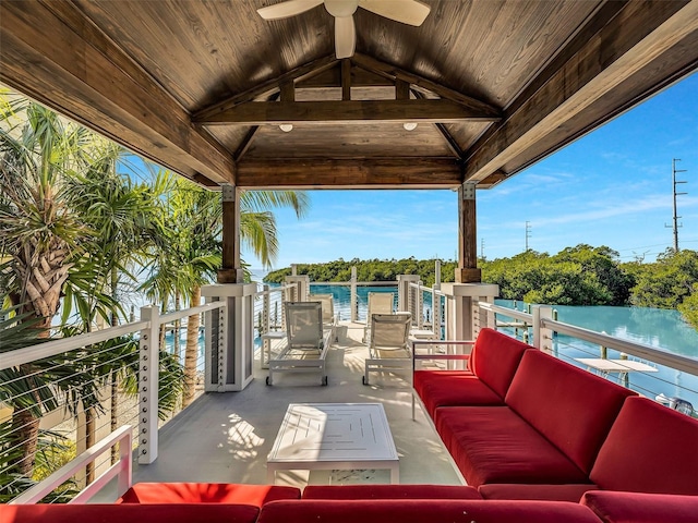 view of patio / terrace with ceiling fan, a balcony, a water view, and an outdoor hangout area