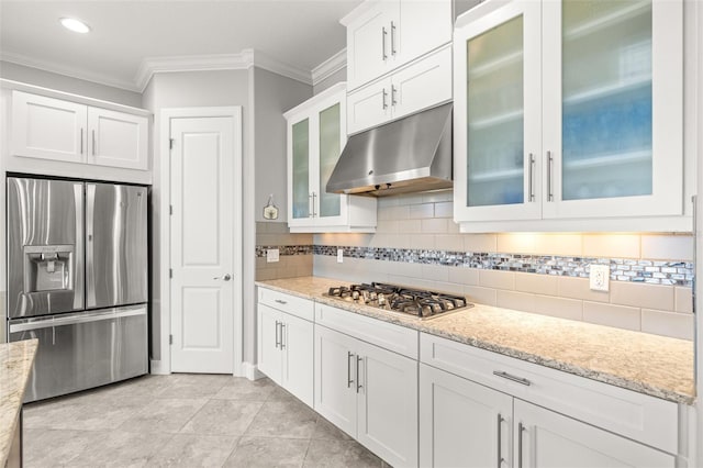 kitchen with backsplash, light stone counters, stainless steel appliances, crown molding, and white cabinets