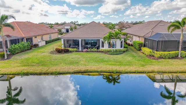 back of house with a yard and a water view