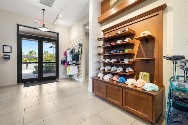 entrance foyer with french doors, light tile patterned flooring, and track lighting