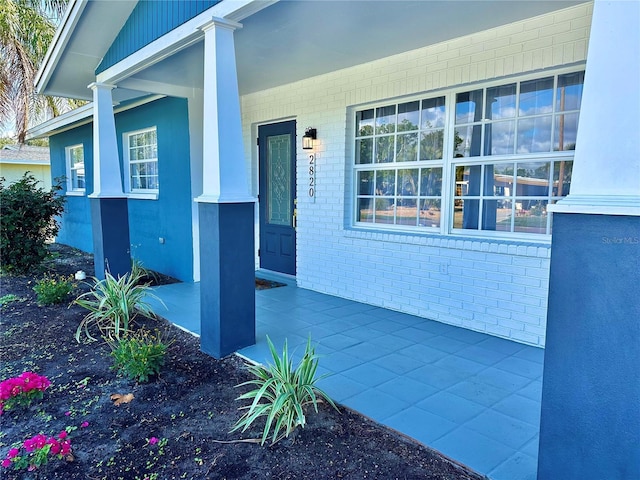 property entrance with brick siding