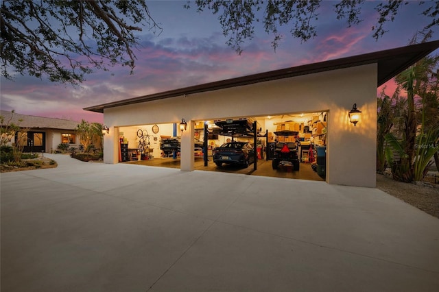 view of garage at dusk