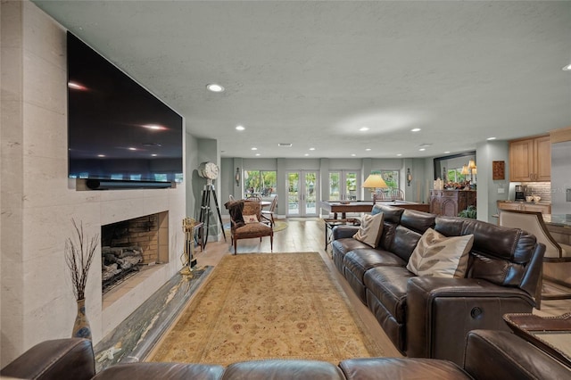 living room with light wood-type flooring and a fireplace