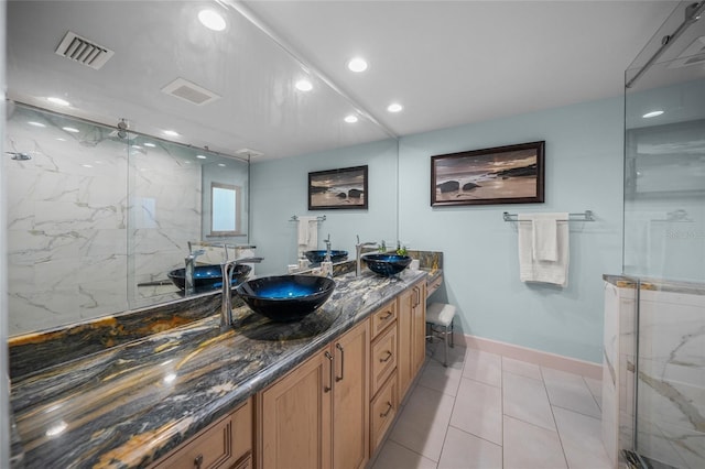 bathroom featuring tile patterned flooring, vanity, and an enclosed shower