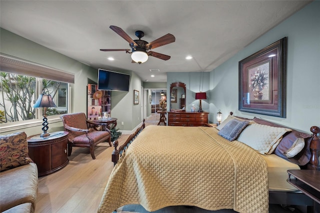 bedroom with ceiling fan and light hardwood / wood-style floors