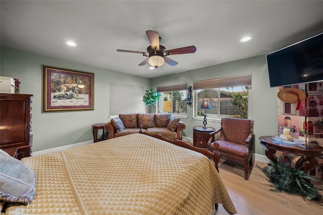 bedroom with ceiling fan and light hardwood / wood-style floors