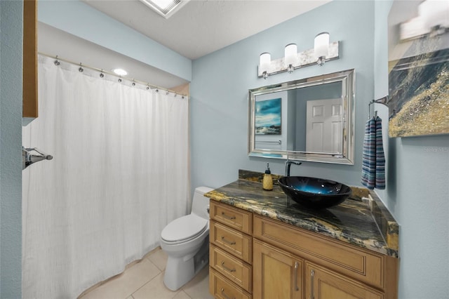 bathroom with tile patterned flooring, vanity, and toilet