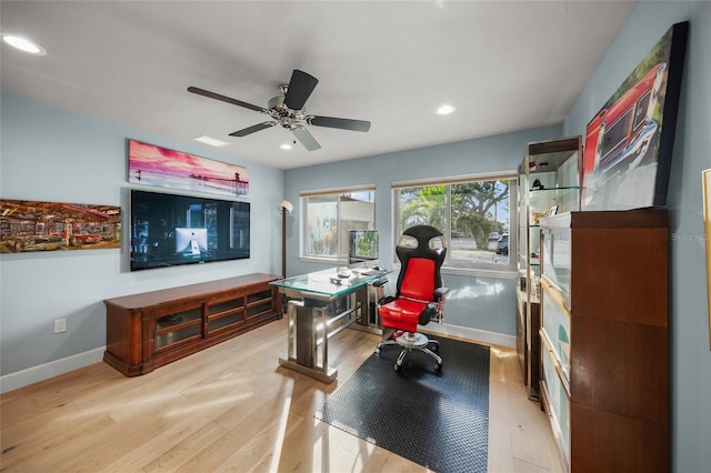 home office featuring ceiling fan and light hardwood / wood-style flooring