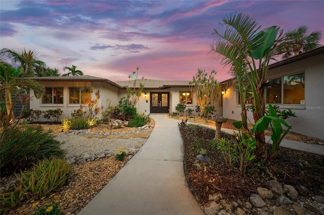 ranch-style home featuring french doors