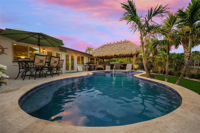 pool at dusk featuring a gazebo, french doors, and a patio