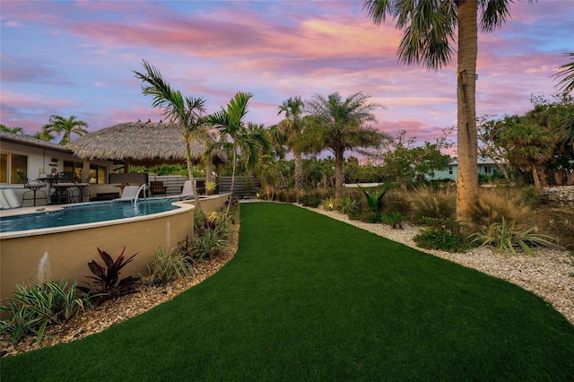 yard at dusk with a gazebo