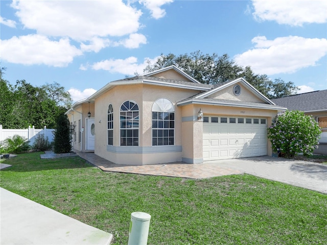 view of front of home featuring a garage and a front lawn