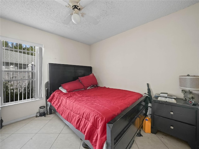 bedroom featuring light tile patterned floors, a textured ceiling, and ceiling fan