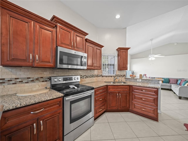 kitchen with decorative backsplash, stainless steel appliances, ceiling fan, sink, and lofted ceiling