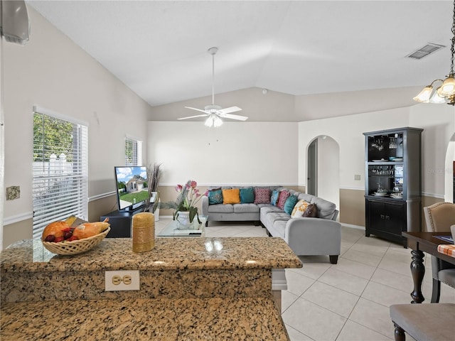 tiled living room featuring ceiling fan and lofted ceiling