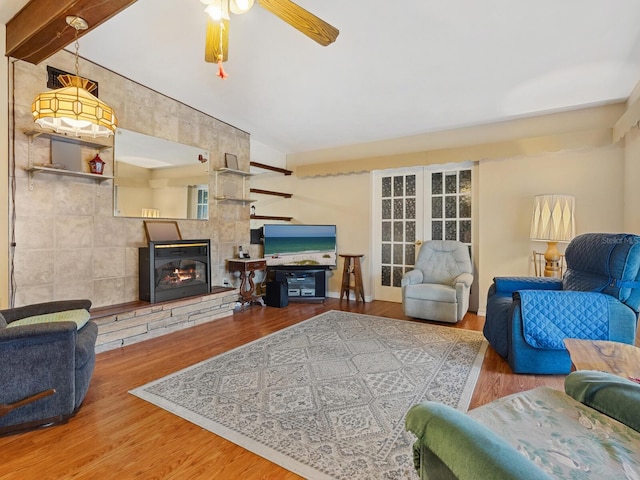 living room featuring hardwood / wood-style floors, a fireplace, and ceiling fan