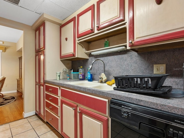 kitchen with dishwasher, sink, decorative backsplash, light tile patterned floors, and a drop ceiling