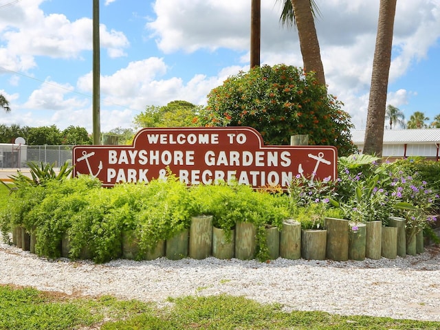 community / neighborhood sign featuring fence