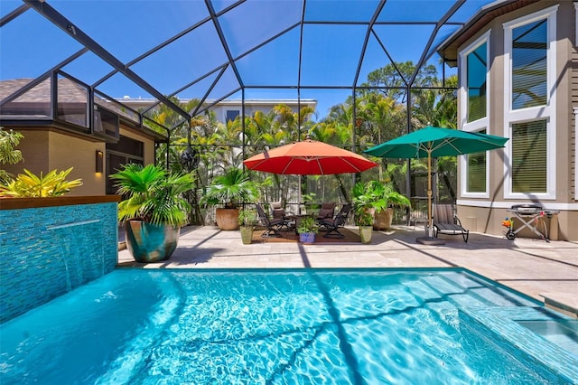 view of swimming pool with glass enclosure and a patio area