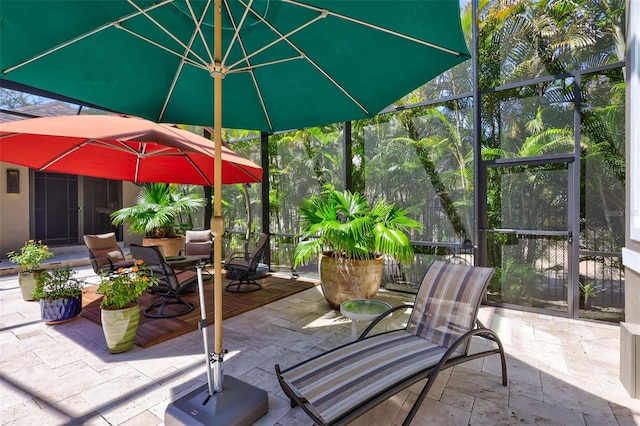 view of patio with glass enclosure