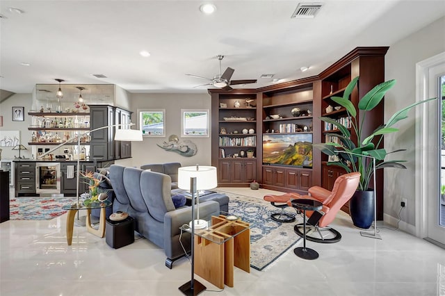 sitting room featuring indoor bar, wine cooler, and ceiling fan