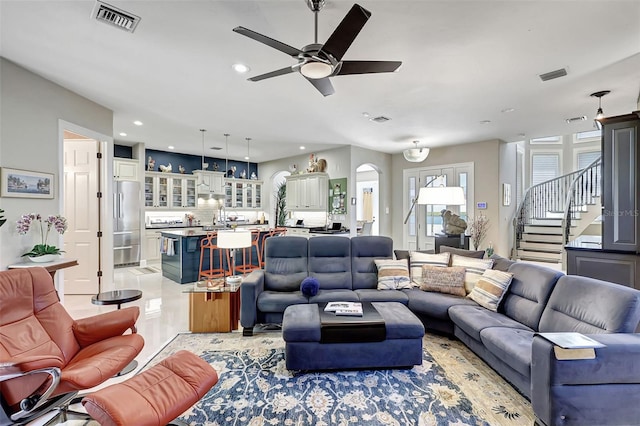 tiled living room with ceiling fan