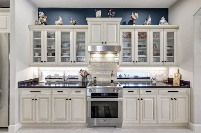 kitchen featuring white cabinetry, decorative backsplash, and appliances with stainless steel finishes