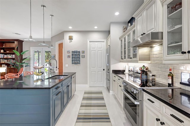 kitchen featuring decorative light fixtures, white cabinetry, sink, and stainless steel appliances