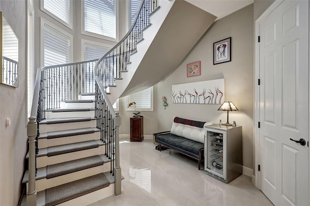 stairs with tile patterned flooring and beverage cooler