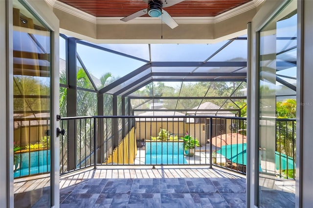 unfurnished sunroom featuring ceiling fan and wooden ceiling