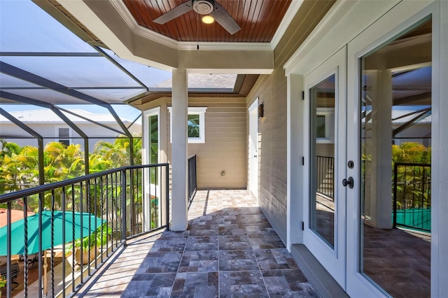 balcony featuring a patio area, ceiling fan, and french doors