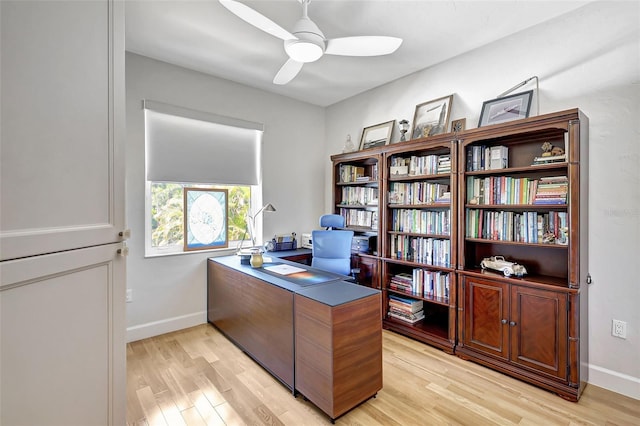 home office featuring light wood-type flooring and ceiling fan