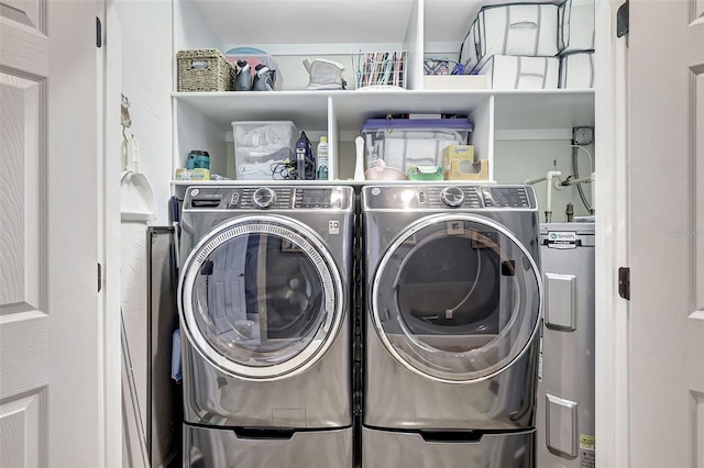 laundry area featuring water heater and washing machine and clothes dryer