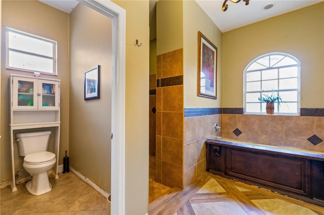 bathroom featuring tile patterned flooring, toilet, tile walls, and plus walk in shower