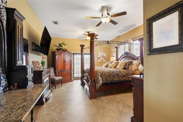 tiled bedroom featuring ceiling fan