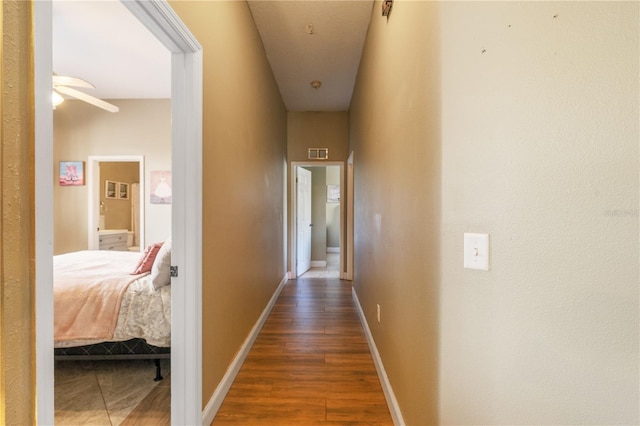 corridor with dark hardwood / wood-style floors