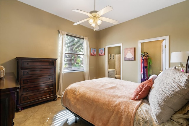 tiled bedroom with ensuite bath, ceiling fan, a closet, and a walk in closet